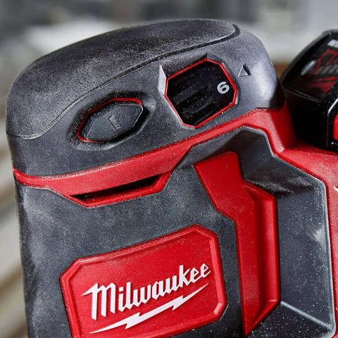 Close-up of Slick Cordless Random Orbit Sander Kit With M18 Battery Pack showing control buttons and battery indicator.
