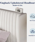 Close-up of the Wingback Upholstered Headboard of White Queen Velvet Bed Frame With Upholstered Wingback Headboard And Vertical Tufted Design.