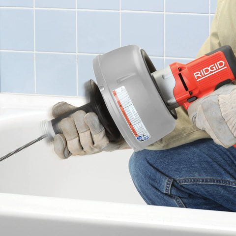 Professional Grade Pneumatic Air Powered 230V Drain Cleaning Tool being used for stubborn residential clogs in a bathtub.