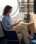 Person reading beside Ultra Thin 7 Inch Portable Travel Fan Must Have With 8000mAh Battery, 28 Hours Runtime, Quiet Rechargeable Desk Fan in cabin.