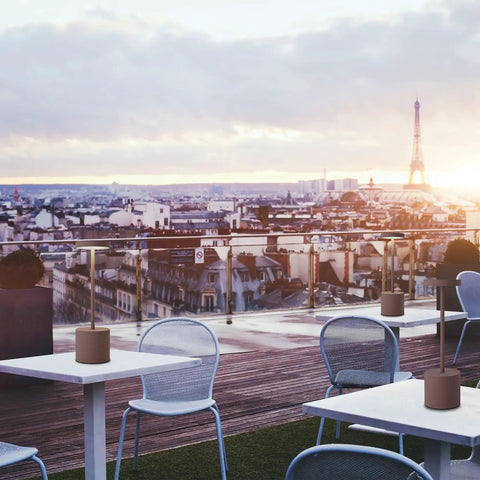 Outdoor cafe with LED Cordless Table Lamp Set Of 2, Portable Rechargeable Battery Powered Lighting, Paris skyline in background