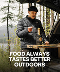 Man with a portable electric kettle enjoying noodles outdoors, showcasing camping gear by car.