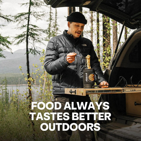 Man with a portable electric kettle enjoying noodles outdoors, showcasing camping gear by car.