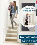 Woman and child descending stairs with Guard Me Retractable Safety Gate for Extra Wide Openings 21.6 to 44.6 Inches visible in use