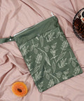 Green Dual Compartment Wet Dry Bag with leaf design on pink fabric, ideal for baby diapers, swimsuits, and wet clothes.