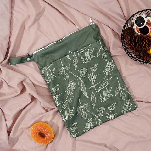 Green Dual Compartment Wet Dry Bag with leaf design on pink fabric, ideal for baby diapers, swimsuits, and wet clothes.