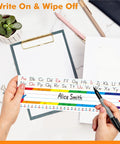 Hands holding 40 Pack Waterproof Desk Name Plates With Alphabet And Number Line 1-30 Traditional Manuscript Style For Classroom.