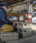Man using Divided Ammo Crate Utility Box With Seven Compartments Water Resistant And Lockable Ammo Storage For 5.56 9mm 12 Gauge
