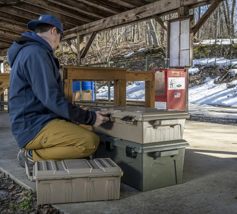 Man using Divided Ammo Crate Utility Box With Seven Compartments Water Resistant And Lockable Ammo Storage For 5.56 9mm 12 Gauge