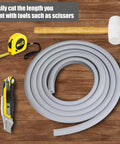 Built Tough Flexible Epdm Rubber Strip Trial Pack next to tape measure, utility knife, and mallet for driveway cracks.