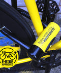 Close-up of yellow New York Fahgettaboutit Mini Bike U Lock With 18mm Hardened Shackle securing bicycle frame, e-bike approved