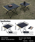 Small black ultralight camping folding table with carry bag, aerospace-grade aluminum, on grass, supports up to 66 lbs