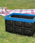Heavy Duty Collapsible Storage Bin With 12 Gallon Capacity And Built In File Organizer Rails For Home Office Garage Car Trunk Folding Plastic Tote With Easy Grip Handles Black Blue on grass outdoors.