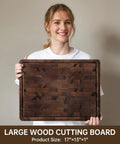 Top Shelf Solid Walnut End Grain Cutting Board Heavy Duty Kitchen Prep Surface With Deep Juice Channels 17X13X1 Inch held by a smiling woman.