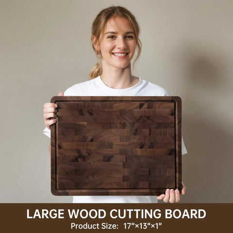 Top Shelf Solid Walnut End Grain Cutting Board Heavy Duty Kitchen Prep Surface With Deep Juice Channels 17X13X1 Inch held by a smiling woman.