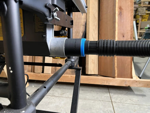Side view of One Seven Eight Inch Hose Adapter For Two And One Quarter Inch Table Saw Dust Ports With Quick Twist Lock Compatible With Dewalt Milwaukee And Ridgid Saws Made In USA Keeps Dust Contained And Workspace Clean connected to table saw.