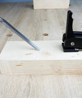 Two Pack Three Quarter Inch Aluminum Alloy Bench Dog Clamps For Woodworking With No Sweat One Hand Quick Release Lever and Rock Solid Hold Down Grip For Hassle Free Benchtop Workholding, in use holding wood.