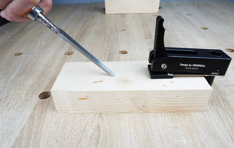 Two Pack Three Quarter Inch Aluminum Alloy Bench Dog Clamps For Woodworking With No Sweat One Hand Quick Release Lever and Rock Solid Hold Down Grip For Hassle Free Benchtop Workholding, in use holding wood.