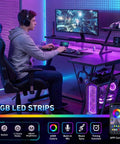 Gamer using 40 Inch Gaming Desk With LED Lights And Built In Power Outlets, L Shaped Corner Desk With Storage Shelves And Reversible Monitor Stand