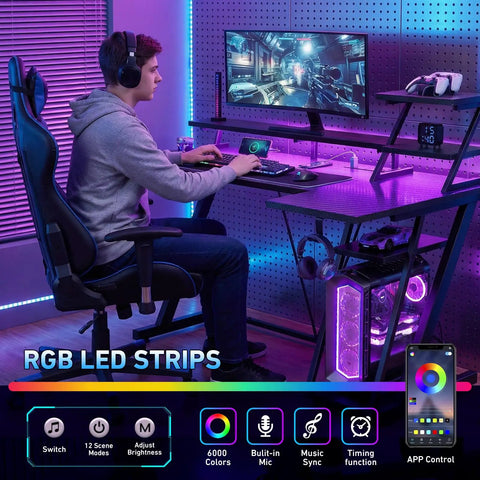 Gamer using 40 Inch Gaming Desk With LED Lights And Built In Power Outlets, L Shaped Corner Desk With Storage Shelves And Reversible Monitor Stand