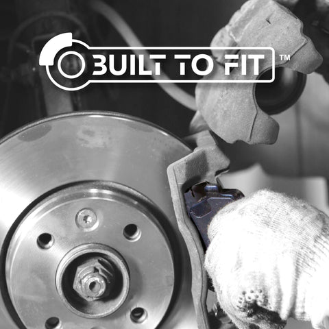 Centric Premium 301.09050 rear ceramic brake pads set on a brake caliper with rotor
