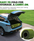 Premium Dual Turf Golf Mat for Backyard and Driving Range in car trunk, rolled up, showing easy storage and transport features.