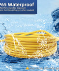 Heavy Duty 25 Foot 12 Gauge Outdoor Extension Cord With Lighted End, waterproof yellow cable coiled on wet surface.