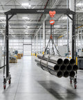 Workhorse Grade Adjustable Gantry Crane 4400 Lbs Capacity Portable Shop Lift Hoist With Manual Trolley Kit lifting steel pipes in a warehouse.
