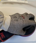 Hand holding a sander with 3M Cubitron II Hookit Abrasive Disc on a smooth surface for auto work.