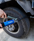 8000 PSI Heavy Duty Lever Action Grease Gun Kit with 14oz Aluminum Barrel being used on vehicle tire.
