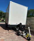 Monster Tug Off-Road Trailer Dolly Moves Boat, RV, Or Utility Trailer With Ease On Sand, Dirt, Gravel, Concrete Hard Surfaces Heavy Metal Frame Manual Mover No Motor Needed Adjustable Ball Mount For Any Tow, with a view of a trailer and dolly on paved surface.