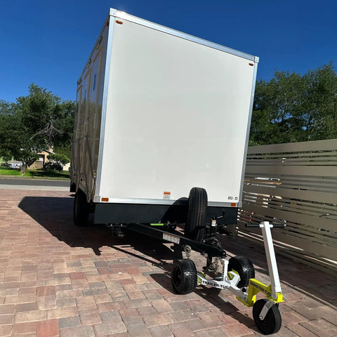 Monster Tug Off-Road Trailer Dolly Moves Boat, RV, Or Utility Trailer With Ease On Sand, Dirt, Gravel, Concrete Hard Surfaces Heavy Metal Frame Manual Mover No Motor Needed Adjustable Ball Mount For Any Tow, with a view of a trailer and dolly on paved surface.