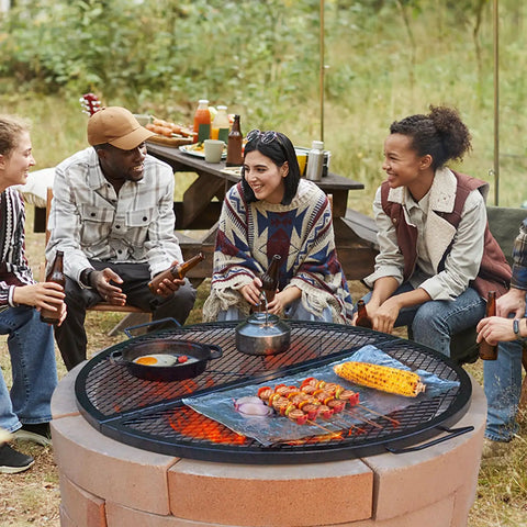 Group enjoying a barbecue on a 36 Inch Round Fire Pit Grate For Outdoor Grillin Foldable Heavy Duty Steel Campfire BBQ Grid