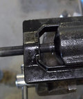 Medium U Joint Puller Tool For Cars Light Trucks And Ag Equipment in use on a driveshaft with heat treated threads visible