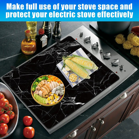 Extra Large Black Marble Stove Top Cover For Electric And Glass Ceramic Cooktops on a kitchen stove, 28.5x20.5 inches, heat resistant.