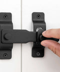Matte Black Stainless Steel Barn Door Latch 4.33 By 3.23 Inch being installed on a white door