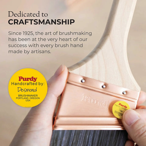 Dedicated craftsmanship shown with a hand holding a Purdy paintbrush featuring a wooden handle and copper ferrule.