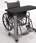 Heavy Duty Adjustable Overbed Table With Ball Bearing Casters, Versatile Rolling Bedside Desk For Hospital Couch Or Wheelchair, No Hassle Portable Laptop Stand For Home next to a wheelchair.
