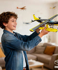 Child holding Epic Seaplane Building Block Set 739 Pieces For Teens And Builders Airplane Model Kit in living room