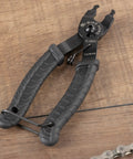 Bike Chain Master Link Pliers 2 In 1 Tool For Easy No Sweat Quick Link Removal And Replacement Compatible With Shimano Sram KMC Chains All Brands MTB Road Use Everyday, black rubber grip handles on wooden surface.