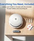 Set It And Forget It Peace Of Mind With This 10 Year Photoelectric Smoke Detector and 10-year battery on wood table.