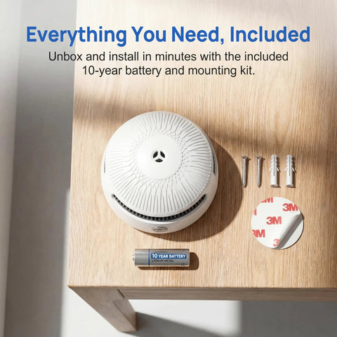 Set It And Forget It Peace Of Mind With This 10 Year Photoelectric Smoke Detector and 10-year battery on wood table.