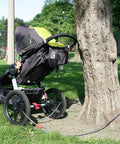 Heavy Duty Security Cable Lock With Loops 10mm Braided Steel securing a stroller to a tree in a park setting