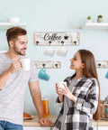 Couple enjoying coffee near a rustic wall mounted coffee mug holder with 12 cup hangers farmhouse wood cup organizer.