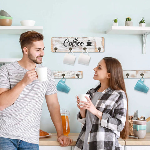 Couple enjoying coffee near a rustic wall mounted coffee mug holder with 12 cup hangers farmhouse wood cup organizer.