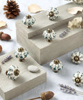 Top Tier Ivory Ceramic Pumpkin Cabinet Knobs Set Of 16 For Kitchen Drawers And Bedroom Furniture With Cute Green Floral Details And Classic Vintage Vibe For Easy Home Makeovers displayed on wooden surfaces.
