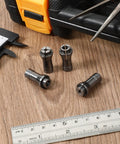4 Piece 1/4 To 1/8 Inch Die Grinder Collet Adapter Set on wooden surface with tools, silver iron finish