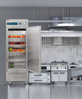 Heavy Kickass Workhorse 27 Inch Wide Commercial Freezer Upright Reach In Single Solid Door 23 Cu Ft Cold Storage with fruits inside.