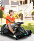 Child riding 12V Electric Kids Go Kart Drift Car With Slow Start Music And Colorful Lights Outdoor Ride On Toy For Ages 8 To 12