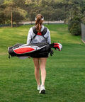 Teen walking on golf course carrying Teen Golf Club Set For Ages 13 To 16 With Titanium Driver, Stainless Hybrid, Stand Bag